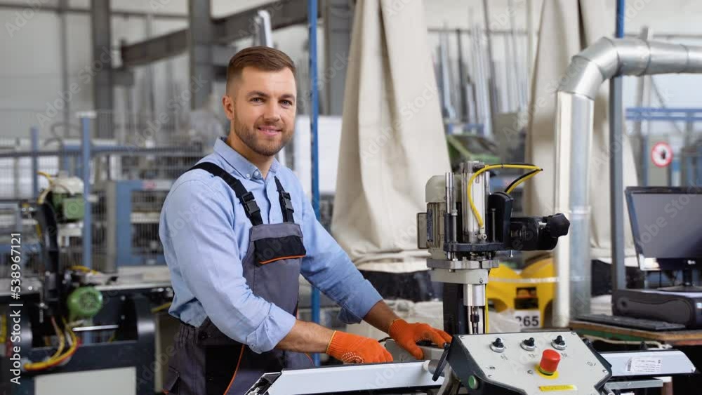 Portrait of manual worker works in a window factory. Aluminum and PVC windows and doors production