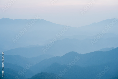 wide view layer of mountain with sunrise background