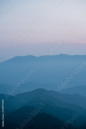wide view  layer of mountain with sunrise background © tickcharoen04