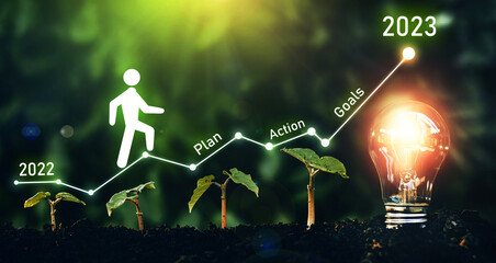 New Year 2023 with plan, action, innovation and goals.	Growing plan of successful business in 2023 year and a figure climbs the ladder of success. 
