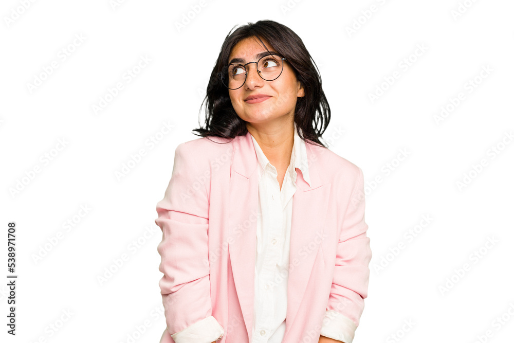 Young Indian business woman wearing a pink suit isolated dreaming of achieving goals and purposes Young Indian business woman wearing a pink suit isolated dreaming of achieving goals and purposes