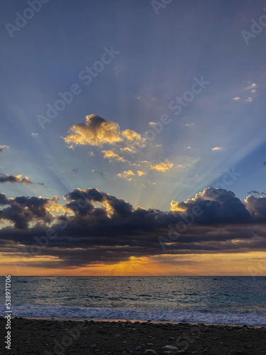 Sunrise landscape with clouds and sea. View of the sun rising above the sea. Selective focus.