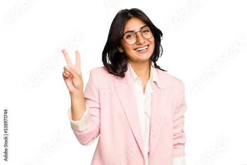 Young Indian business woman wearing a pink suit isolated joyful and carefree showing a peace symbol with fingers.