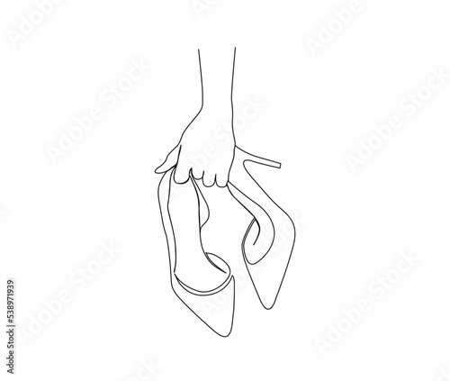 Continuous one line drawing of hand holding elegant highheels shoes. Women stiletto heels line art drawing vector design.