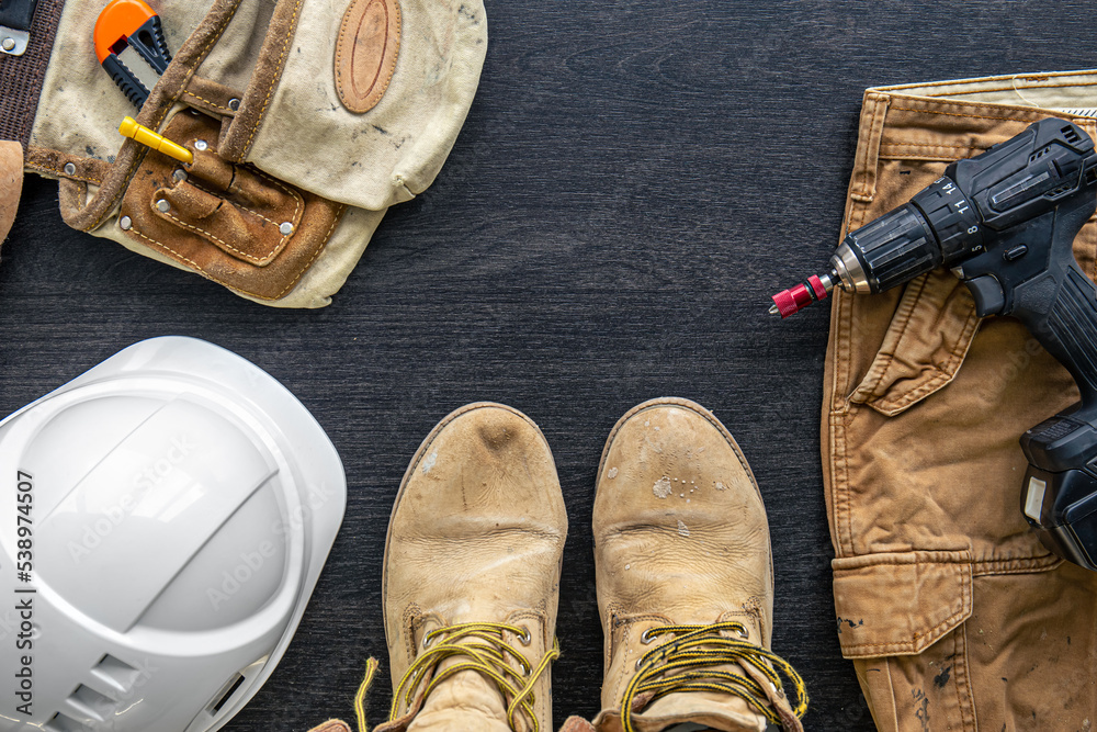 Builder clothes, worker uniform on wooden background, flat lay. Builder clothes, worker uniform on wooden background, flat lay.