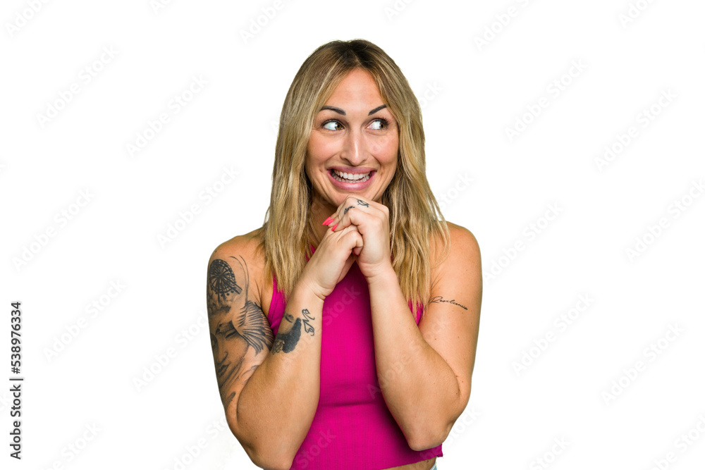 Young caucasian woman isolated on green chroma background keeps hands under chin, is looking happily aside. Young caucasian woman isolated on green chroma background keeps hands under chin, is looking happily aside.