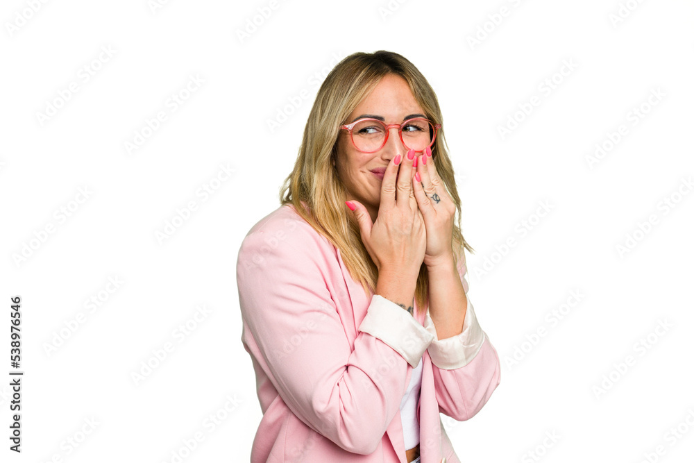 Young caucasian woman isolated on green chroma background laughing about something, covering mouth with hands.