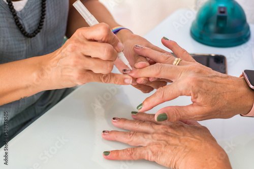 Hand Care. Close-up of female hands being manicured at a beauty salon.