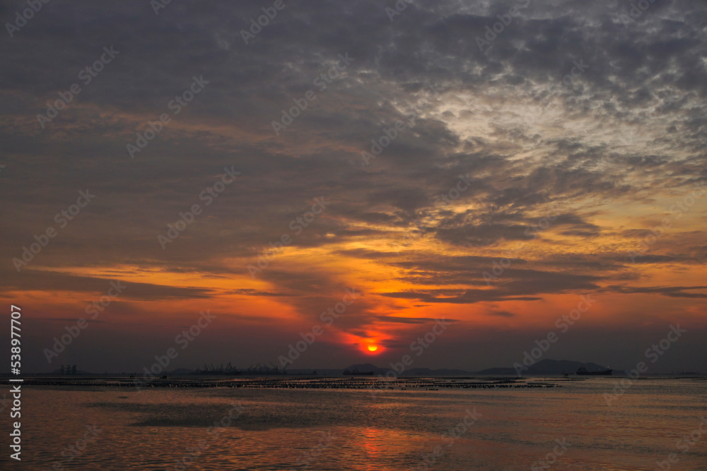 Sunset sky at sea with Si Chang island silhouette background