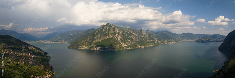 Panorama at Lake Iseo and Mount Corna Trentapassi at sunny day with clouds. Bergamo, Lombardy, Italy.