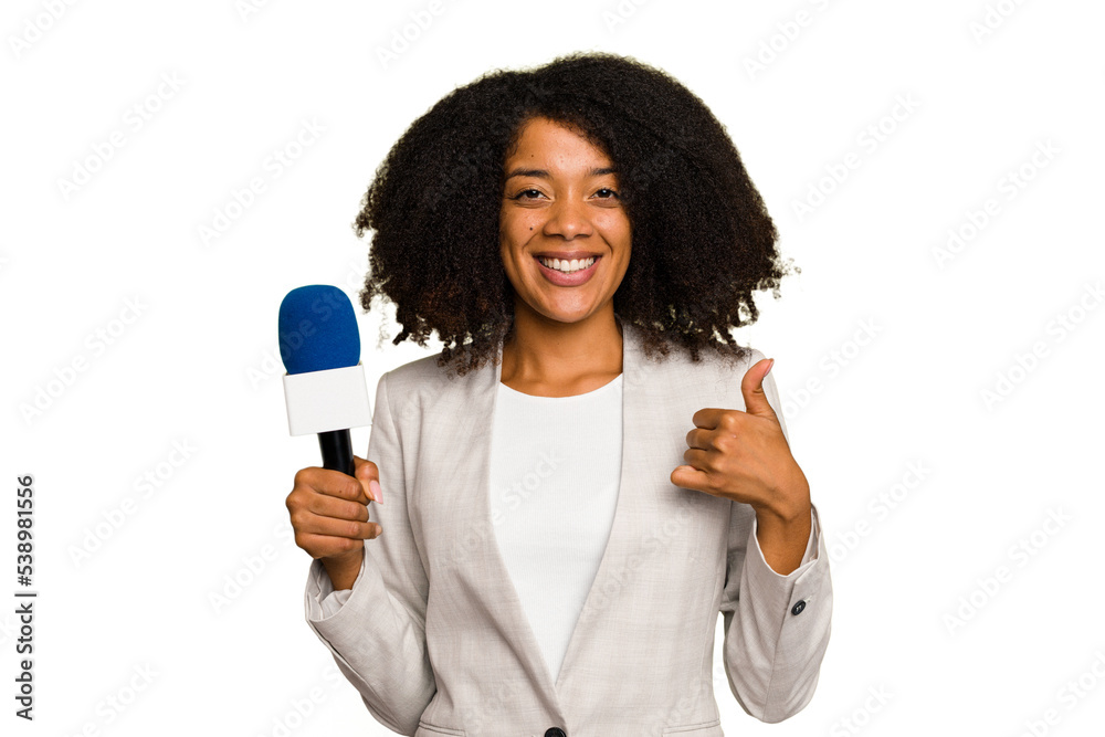 Young TV presenter African American woman with a microphone isolated smiling and raising thumb up Young TV presenter African American woman with a microphone isolated smiling and raising thumb up