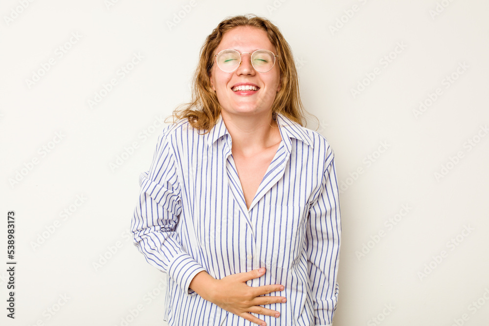 Young caucasian woman isolated on white background touches tummy, smiles gently, eating and satisfaction concept. Young caucasian woman isolated on white background touches tummy, smiles gently, eating and satisfaction concept.