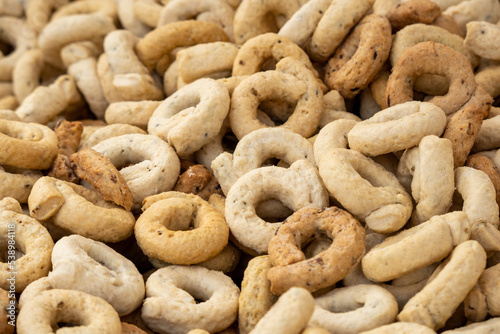 Taralli is a traditional Italian snack food typical of Puglia regional cuisine in wooden bowl. Ingredients: wine, olive oil, salt, flour of wheat