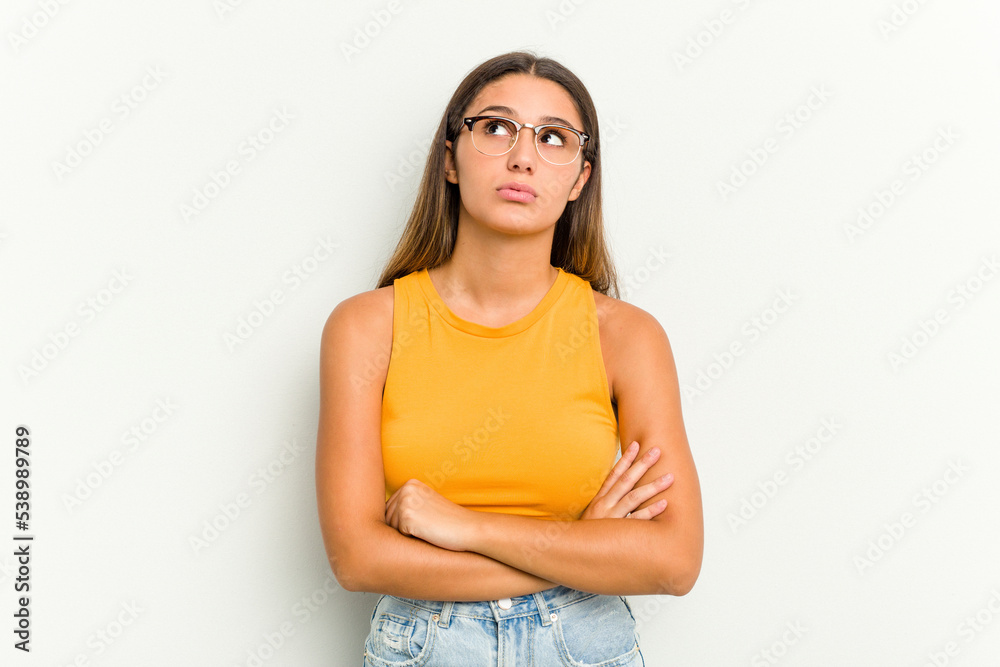 Young Indian woman isolated on white background tired of a repetitive task. Young Indian woman isolated on white background tired of a repetitive task.