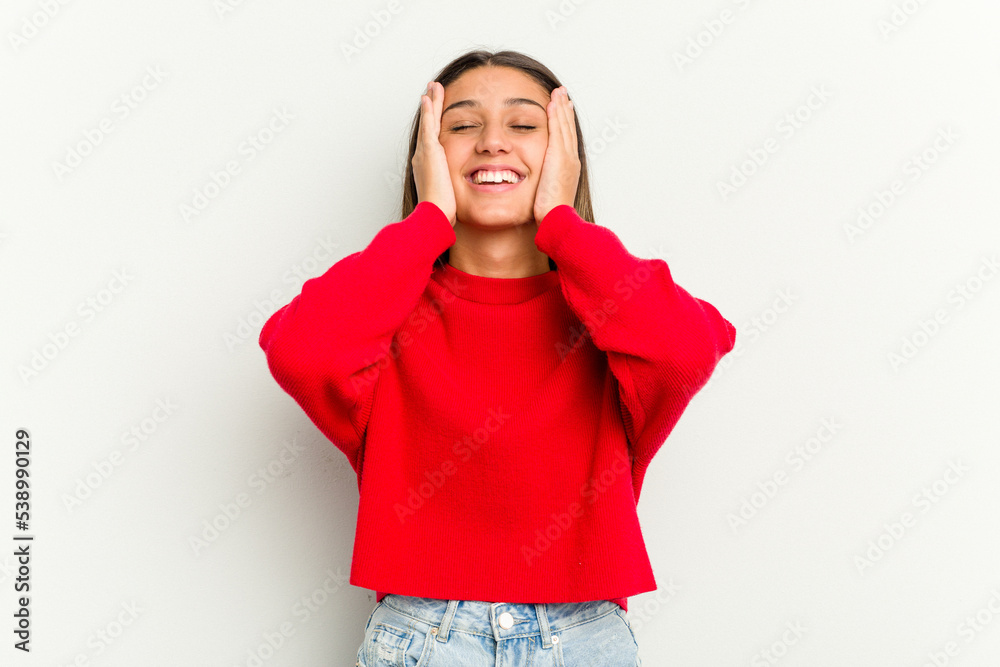 Young Indian woman isolated on white background laughs joyfully keeping hands on head. Happiness concept. Young Indian woman isolated on white background laughs joyfully keeping hands on head. Happiness concept.