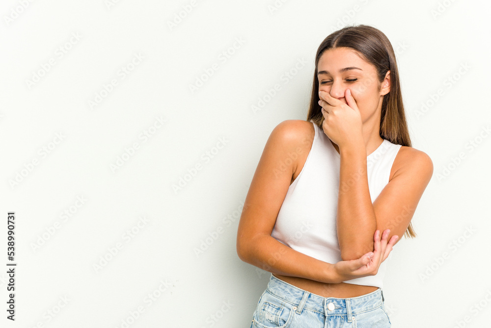 Young Indian woman isolated on white background laughing happy, carefree, natural emotion. Young Indian woman isolated on white background laughing happy, carefree, natural emotion.