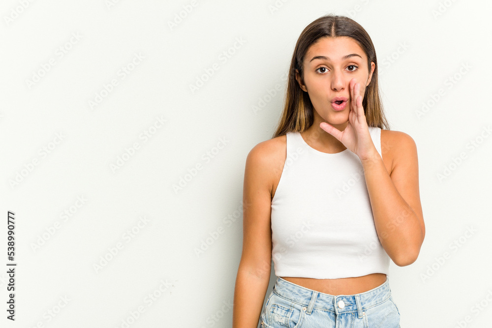 Young Indian woman isolated on white background is saying a secret hot braking news and looking aside Young Indian woman isolated on white background is saying a secret hot braking news and looking aside