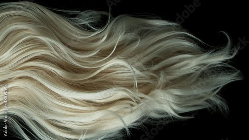 Super slow motion of wavy blonde hair in detail. Filmed on high speed cinema camera, 1000 fps. photo