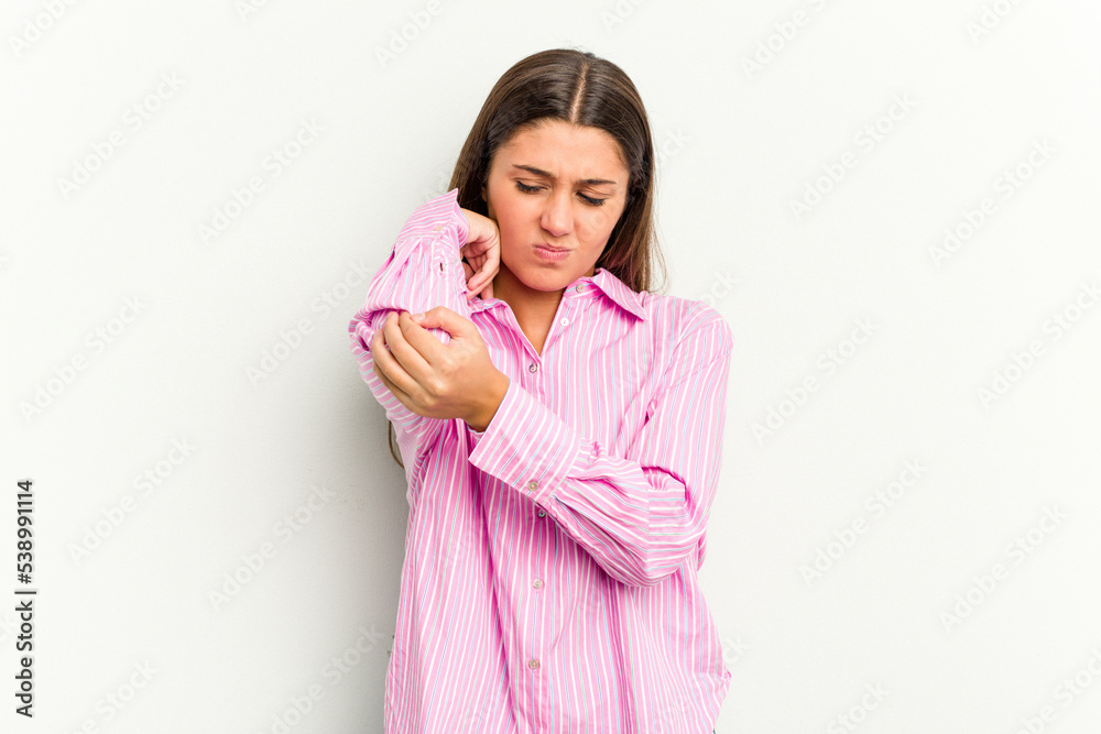 Young Indian woman isolated on white background having a neck pain due to stress, massaging and touching it with hand. Young Indian woman isolated on white background having a neck pain due to stress, massaging and touching it with hand.