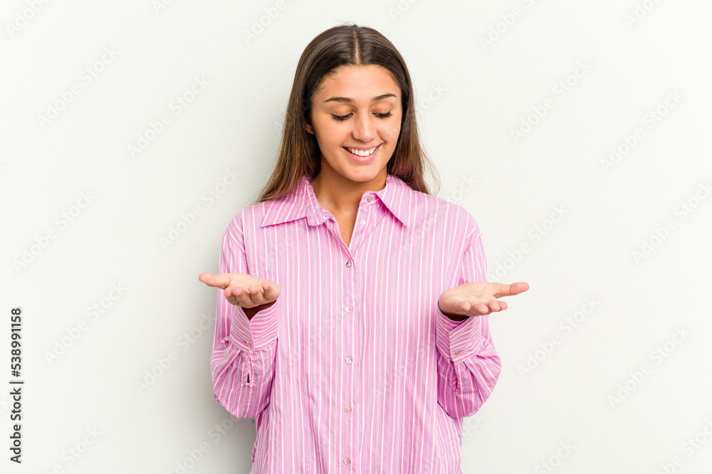 Young Indian woman isolated on white background holding something with palms, offering to camera. Young Indian woman isolated on white background holding something with palms, offering to camera.