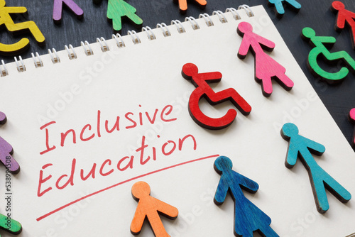 Notepad with phrase Inclusive education and colorful figures.