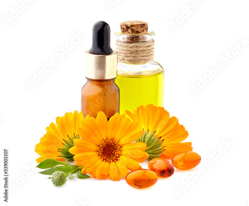 Fototapeta Naklejka Na Ścianę i Meble -  Vitamin capsules with calendula flowers and oil.