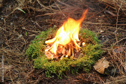 A fire of moss and birch bark