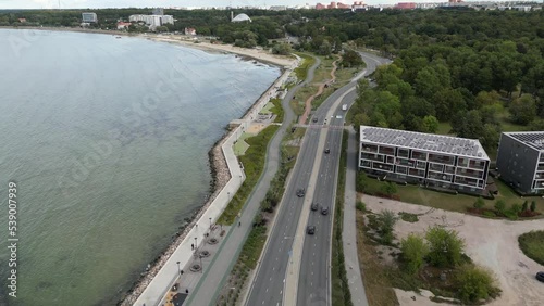 Wallpaper Mural Cars riding on a road next to the seashore. Highway along the sea. Aerial footage, drone flying over a traffic road. Estonia. Green city economy.  Torontodigital.ca