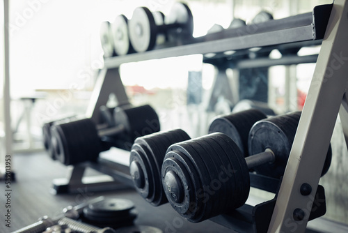 Close-up of heavy barbell for weightlifting on the shelves in sport club