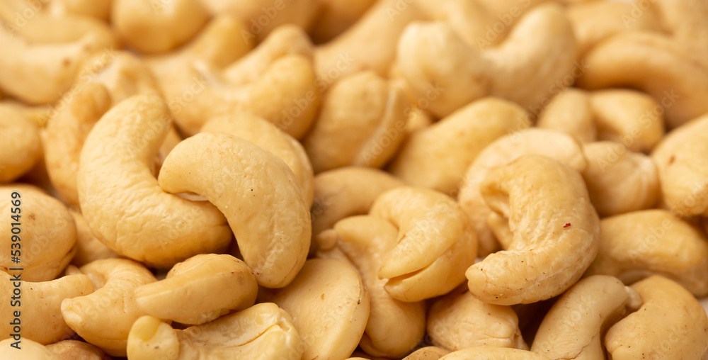 Cashew nuts as a background, top view. Cashew isolated on white background. Healthy foods.