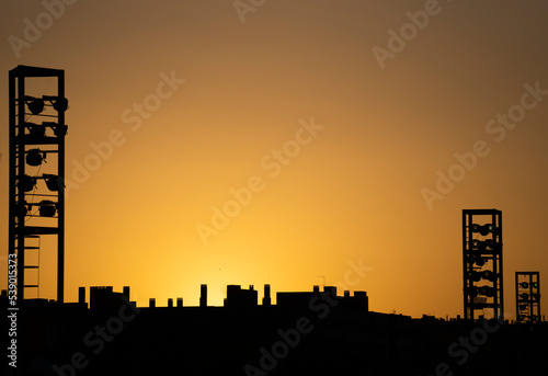 Town City skyline and stadium lights silhouette at sunset. Alcobendas , Madrid , Spain photo