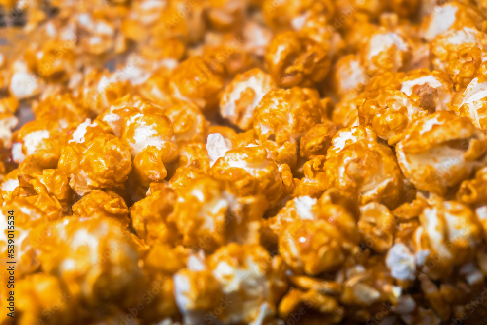 Golden caramel popcorn closeup background Golden caramel popcorn closeup background