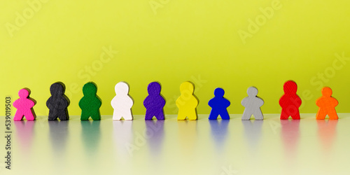 Wooden colorful human-shape figures standing together. Community, team and friendship in group concept.