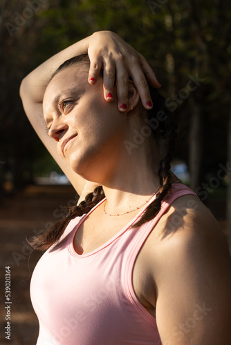 Athletic woman doing relaxing stretching exercises. stretching his neck before training