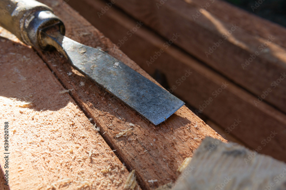 chisel used for work on wooden construction elements, planing of construction beams, woodworking with chisel chisel used for work on wooden construction elements, planing of construction beams, woodworking with chisel