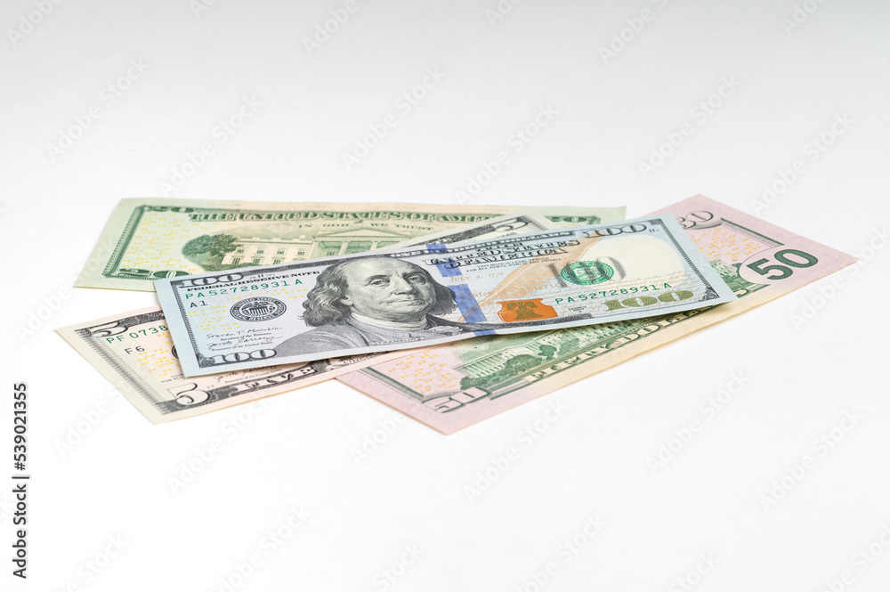 5, 20, 50, 100 dollars banknotes at different angles. Close up of dollars on white background. 5, 20, 50, 100 dollars banknotes at different angles. Close up of dollars on white background.