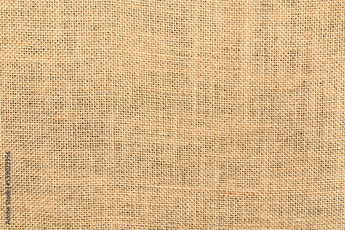 Texture background of natural burlap, close-up with a pronounced texture. Hemp fabric surface - material made from this durable natural fiber and with a uniform woven pattern