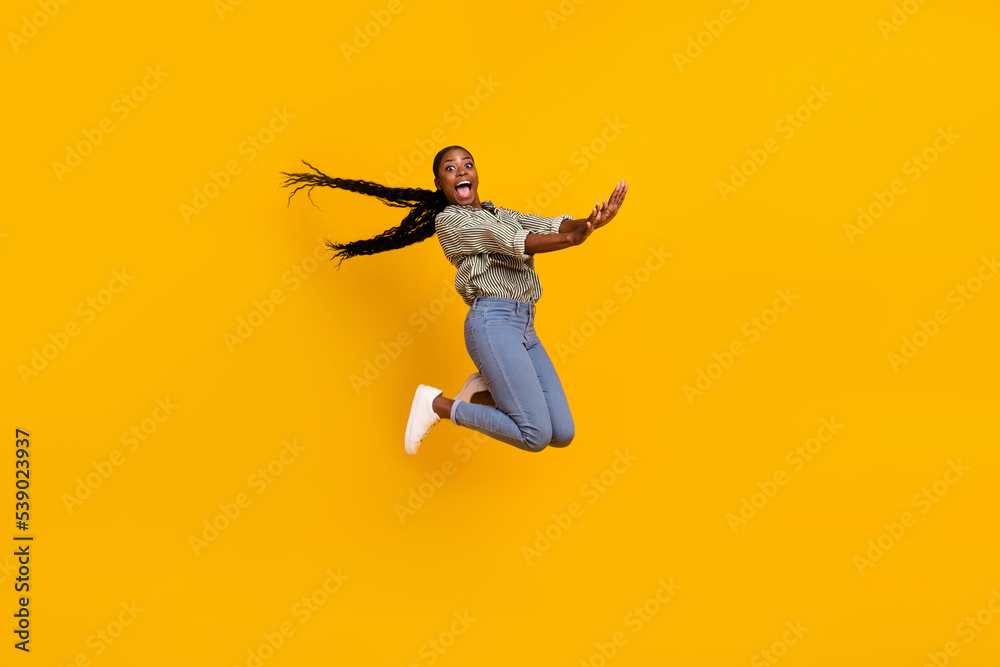 Full body photo of overjoyed active person have good mood jumping fall isolated on yellow color background Full body photo of overjoyed active person have good mood jumping fall isolated on yellow color background