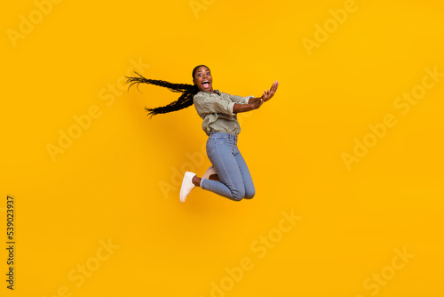 Full body photo of overjoyed active person have good mood jumping fall isolated on yellow color background © deagreez