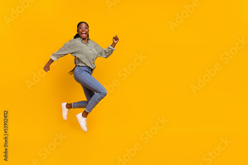Full size profile photo of sportive energetic lady rush hurry fast isolated on yellow color background © deagreez