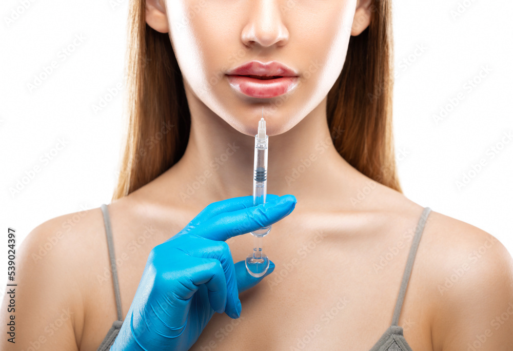 Injections for lips augmentation anti wrinkle injections on the face of a beautiful woman. Female aesthetic cosmetology in a beauty salon. Hematomas after lip contouring. Injections for lips augmentation anti wrinkle injections on the face of a beautiful woman. Female aesthetic cosmetology in a beauty salon. Hematomas after lip contouring.