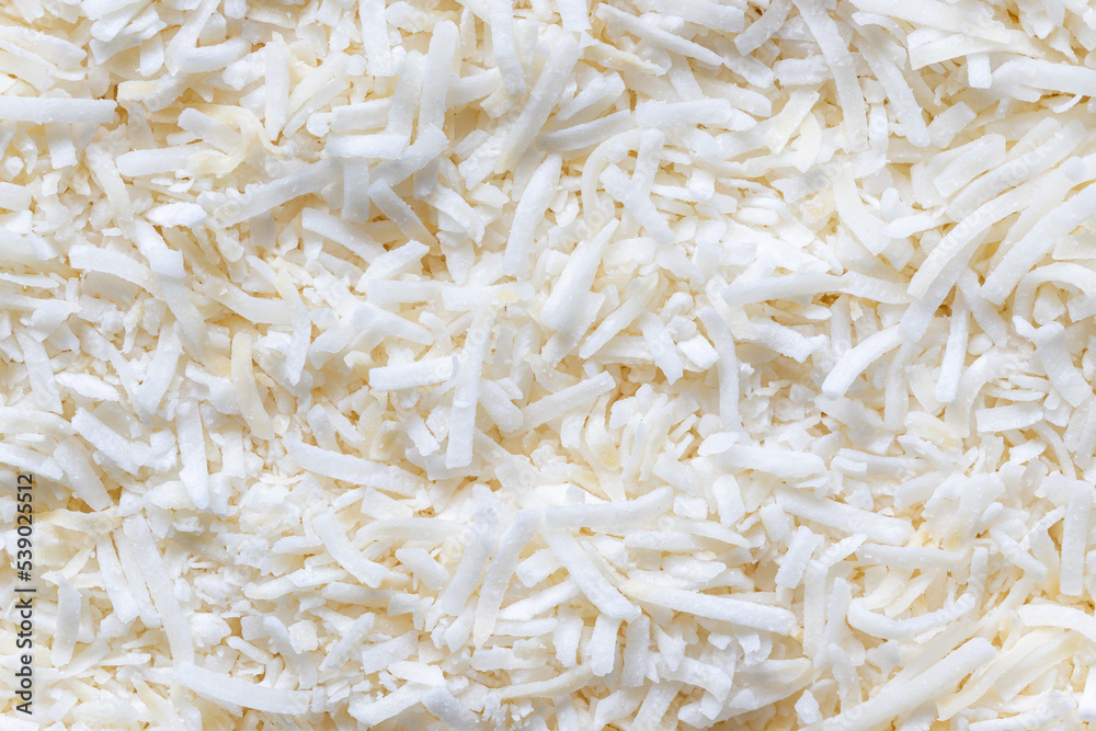 Coconut flakes background. Top view, close up of shredded white fruit