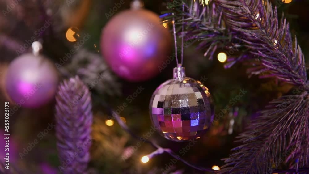 Classic Christmas New Year decorated New year tree with silver white pink ornament decorations defocused garland lights fireworks light. Modern classical holiday design. Christmas eve at home Classic Christmas New Year decorated New year tree with silver white pink ornament decorations defocused garland lights fireworks light. Modern classical holiday design. Christmas eve at home