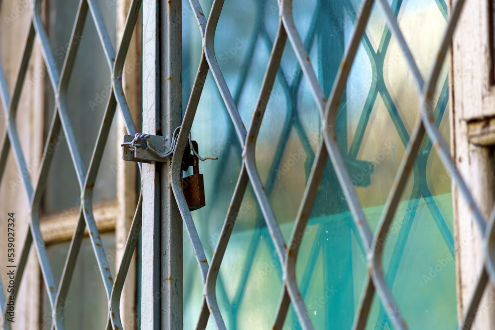 Window with metal grille locked from the inside Window with metal grille locked from the inside