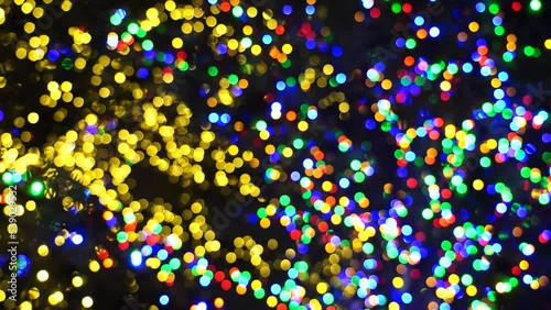 A lot of lights of red yellow blue green colors, the effect of blurring the lights. Illumination on Christmas tree