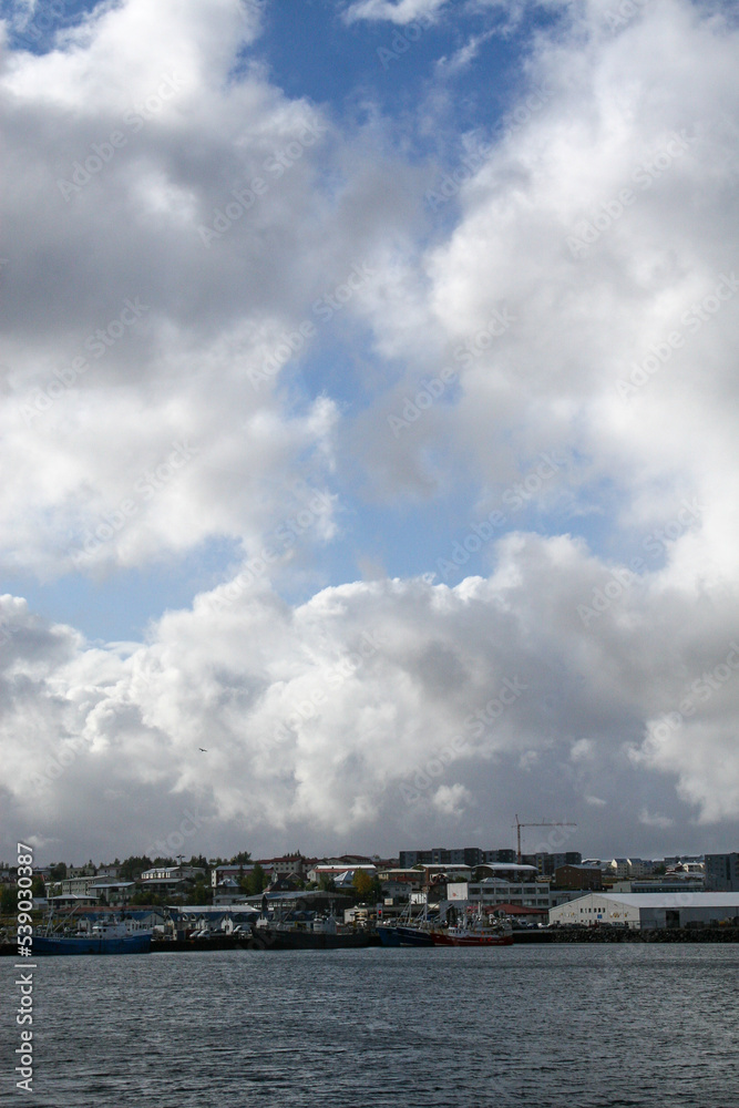 Reykjavik, Iceland - Reykjavik’s coastline, under a cloudy blue sky. Image has copy space. Reykjavik, Iceland - Reykjavik’s coastline, under a cloudy blue sky. Image has copy space.