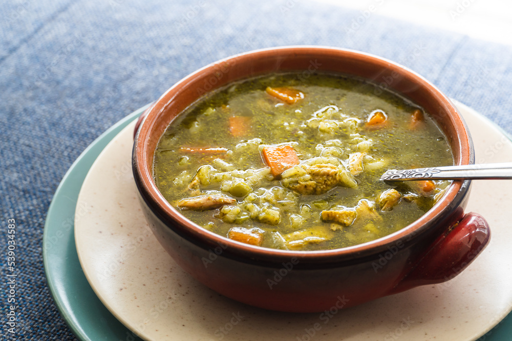 Peruvian food soup with cilantro, carrots and chicken called aguadito. Peruvian food soup with cilantro, carrots and chicken called aguadito.