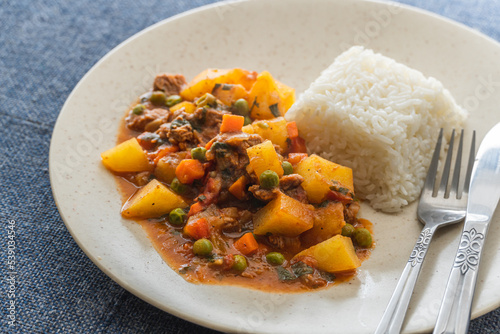 Peruvian stew picante of meat with meat, rice, potatoes and vegetables.