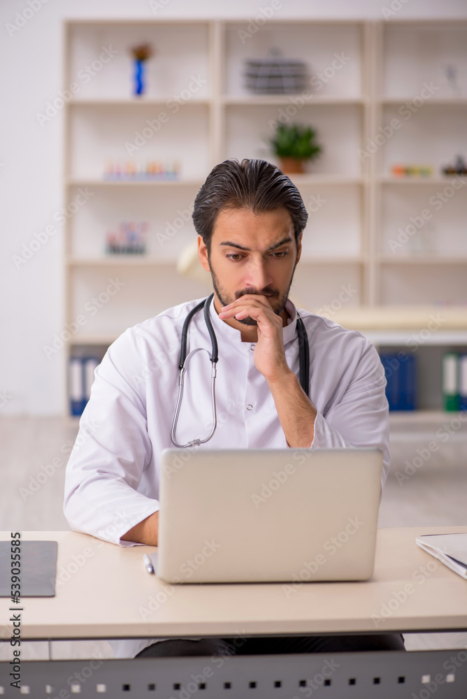 Young male doctor in telemedicine concept Young male doctor in telemedicine concept