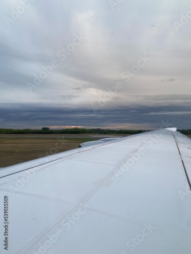 Travelling by air plane, looking through plane window, skies above and below View from Window © Malvina